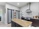 Kitchen showcasing granite countertops, stainless steel appliances, and a sliding door pantry at 7351 Spring Mountain Ln, Yalaha, FL 34797