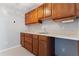 View of kitchenette area with wood cabinets, countertop, sink, and outlets at 7351 Spring Mountain Ln, Yalaha, FL 34797