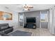 Comfortable living room with a large television and windows at 7351 Spring Mountain Ln, Yalaha, FL 34797