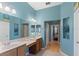 Spacious bathroom boasting a double sink vanity with wood cabinets and ample counter space at 7351 Spring Mountain Ln, Yalaha, FL 34797