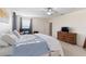 Spacious bedroom with a bed, desk, and dresser featuring neutral colors and natural light at 7351 Spring Mountain Ln, Yalaha, FL 34797