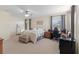 Large bedroom with neutral colors and a ceiling fan includes a bed, dresser, and desk at 7351 Spring Mountain Ln, Yalaha, FL 34797