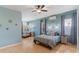 Light and airy bedroom featuring wood floors, accent lighting, and ensuite bath at 7351 Spring Mountain Ln, Yalaha, FL 34797