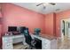 Spacious office featuring hardwood floors, ceiling fan, and two large desks at 7351 Spring Mountain Ln, Yalaha, FL 34797