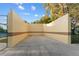 Outdoor racquetball court with concrete walls and gated access for recreational use at 7351 Spring Mountain Ln, Yalaha, FL 34797