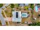 Aerial view of the property showing the house layout, screened in pool, and surrounding greenery at 8444 Sandberry Blvd, Orlando, FL 32819