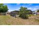Spacious backyard features a screened pool, shed, and mature trees, offering privacy and outdoor enjoyment at 8444 Sandberry Blvd, Orlando, FL 32819
