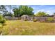 A spacious backyard featuring a shed and pergola for outdoor relaxation at 8444 Sandberry Blvd, Orlando, FL 32819