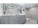 Bathroom features large mirror, dual vanities, and glass shower at 8444 Sandberry Blvd, Orlando, FL 32819