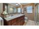 Bathroom features double sinks with granite counters and a shower with glass doors at 8444 Sandberry Blvd, Orlando, FL 32819