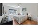 Bright bedroom with hardwood floors, and large window at 8444 Sandberry Blvd, Orlando, FL 32819