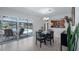 Dining area with a view of the pool and patio through sliding glass doors, adjacent to the kitchen at 8444 Sandberry Blvd, Orlando, FL 32819