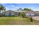 Charming single-story home with a manicured front lawn and a two-car garage in a residential neighborhood at 8444 Sandberry Blvd, Orlando, FL 32819