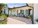 Cozy front porch with rocking chairs and floral accents offering a welcoming entryway at 8444 Sandberry Blvd, Orlando, FL 32819