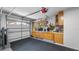 The garage includes a workbench, storage cabinets, and organization solutions for tools and projects at 8444 Sandberry Blvd, Orlando, FL 32819
