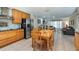 Open kitchen with stainless steel appliances, wooden cabinetry, and views into a comfortable living room at 8444 Sandberry Blvd, Orlando, FL 32819