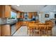 Kitchen features wooden cabinets, stainless steel appliances, granite countertops, and an adjacent breakfast nook at 8444 Sandberry Blvd, Orlando, FL 32819