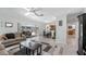 Bright living room featuring sliding glass doors to the lanai, light colored floors, and neutral decor at 8444 Sandberry Blvd, Orlando, FL 32819