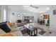 Bright living room featuring sliding glass doors to the lanai, light colored floors, and neutral decor at 8444 Sandberry Blvd, Orlando, FL 32819