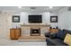 Living area with a fireplace, mantel, mounted television, and tile flooring providing a cozy space for entertaining at 8444 Sandberry Blvd, Orlando, FL 32819