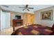 Main bedroom featuring a cozy bed, fireplace, TV and spacious closet at 8444 Sandberry Blvd, Orlando, FL 32819