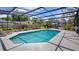 A pristine pool is surrounded by lounge chairs and lush landscaping at 8444 Sandberry Blvd, Orlando, FL 32819