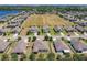 Aerial view of homes in a neighborhood with lush landscaping and a serene lake in the background at 865 Bay Bridge Cir, Apopka, FL 32703