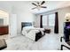 This bedroom features tile floors, a ceiling fan, and windows with beautiful natural light at 865 Bay Bridge Cir, Apopka, FL 32703