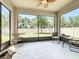 Screened-in lanai with outdoor seating, ceiling fan, and view to the backyard at 865 Bay Bridge Cir, Apopka, FL 32703