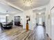 Bright foyer with wood-look tile flooring, chandelier, and dining room view at 865 Bay Bridge Cir, Apopka, FL 32703