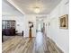 Bright foyer with wood-look tile flooring, chandelier, and dining room access at 865 Bay Bridge Cir, Apopka, FL 32703