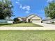 Charming single-story home featuring a well-manicured lawn and attached two-car garage at 865 Bay Bridge Cir, Apopka, FL 32703
