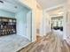 Hallway featuring modern tile, open office, and access to the main living area at 865 Bay Bridge Cir, Apopka, FL 32703