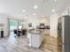 Bright kitchen featuring granite counters, stainless steel appliances, and adjacent dining area at 865 Bay Bridge Cir, Apopka, FL 32703