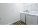 This laundry room features a washer and dryer set and a wire storage shelf at 865 Bay Bridge Cir, Apopka, FL 32703