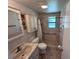 Functional bathroom with tiled walk-in shower, vanity, and grab bars for accessibility at 951 Cr 453, Lake Panasoffkee, FL 33538
