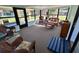 Bright sunroom furnished with comfortable wicker seating and large windows offering natural light at 951 Cr 453, Lake Panasoffkee, FL 33538