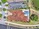 An aerial view of the home with a tile roof, brick driveway and back patio area with a pool at 971 Golden Bear Dr, Reunion, FL 34747
