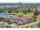 A beautiful two-story home with a terracotta roof adjacent to a golf course and a scenic pond at 971 Golden Bear Dr, Reunion, FL 34747