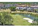 A beautiful lakefront property overlooking a golf course showcasing lush landscaping and a luxury residential community at 971 Golden Bear Dr, Reunion, FL 34747