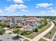 Gorgeous suburban two-story home with a terracotta roof featuring manicured landscaping in a well-maintained neighborhood at 971 Golden Bear Dr, Reunion, FL 34747