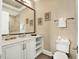 Well-lit bathroom featuring vanity with marble countertops, toilet, and a walk-in shower at 971 Golden Bear Dr, Reunion, FL 34747
