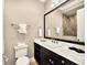 Modern bathroom featuring a large vanity with marble countertop, undermount sink, and tile flooring at 971 Golden Bear Dr, Reunion, FL 34747