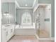 Bright bathroom boasts a soaking tub, a glass enclosed shower, and marble countertops at 971 Golden Bear Dr, Reunion, FL 34747