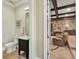 Tastefully designed powder room with dark wood vanity, leading to a well appointed theater room at 971 Golden Bear Dr, Reunion, FL 34747