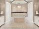 Luxurious bathroom featuring a center soaking tub, arched walk-in showers, and dual vanities with pendant lighting at 971 Golden Bear Dr, Reunion, FL 34747