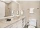 Well-lit bathroom equipped with white vanity, modern toilet, and enclosed shower with a marble tile surround at 971 Golden Bear Dr, Reunion, FL 34747