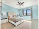 Cozy bedroom featuring carpet, large window, and light blue walls at 971 Golden Bear Dr, Reunion, FL 34747