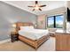 Comfortable bedroom with a wooden bed frame, neutral walls, and a large window that offers serene views at 971 Golden Bear Dr, Reunion, FL 34747
