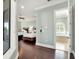 View of Primary bedroom with two beds and bath featuring dark wood floors and light blue walls at 971 Golden Bear Dr, Reunion, FL 34747